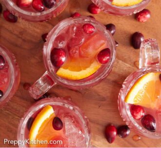 Pinterest graphic of an overhead view of multiple glasses of Christmas punch.