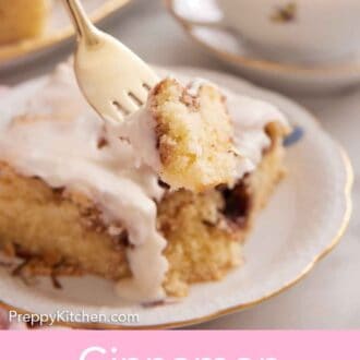 Pinterest graphic of a fork lifting up a bite of a cinnamon roll cake slice on a plate.