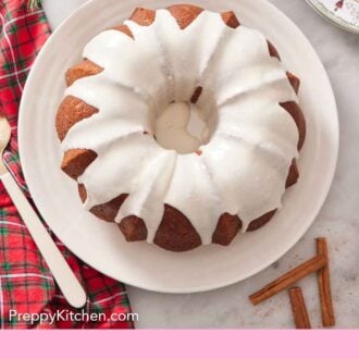 Pinterest graphic of an overhead view of an eggnog cake with icing on top.