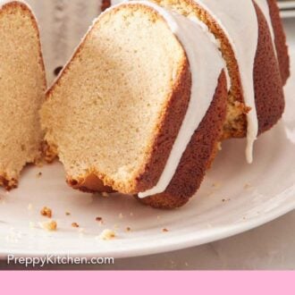 Pinterest graphic of close up view of a slice of eggnog cake slightly pulled away from the rest of a cake.