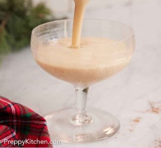 Pinterest graphic of eggnog poured into a glass.