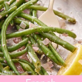 Pinterest graphic of a close up view of a skillet of French green beans with a fork underneath with a wedge of lemon beside it.