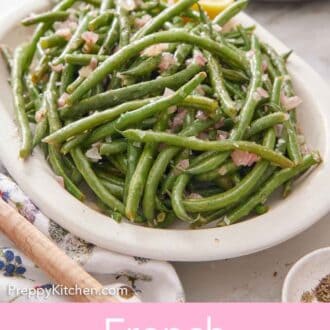 Pinterest graphic of a platter of French green beans surrounded with a wooden spoon and stack of plates off to the side.