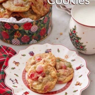Pinterest graphic of a plate with three fruitcake cookies with a tin in the background along with a cup of milk.