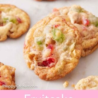 Pinterest graphic of multiple fruitcake cookies on a marble surface.