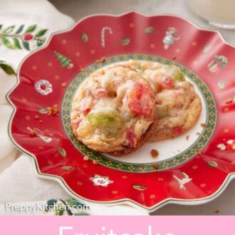 Pinterest graphic of a festive plate with two fruitcake cookies.