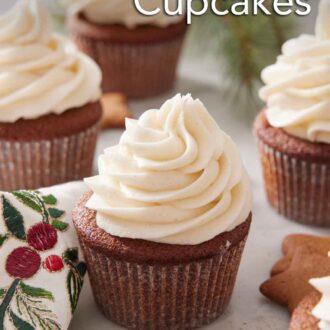 Pinterest graphic of multiple gingerbread cupcakes with cream cheese frosting with gingerbread cookies scattered around.