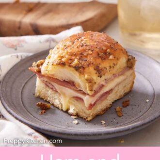 Pinterest graphic of a plate with a ham and cheese slider with an iced drink in the back.