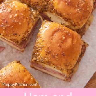 Pinterest graphic of an overhead view of ham and cheese sliders on a serving board with a cut piece pulled out.