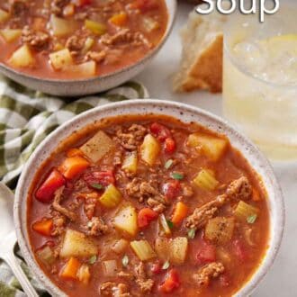 Pinterest graphic of bowls of hamburger soup, one in front, with a drink in the background.