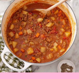 Pinterest graphic of a pot of hamburger soup with a wooden spoon inside.