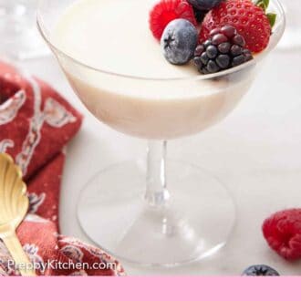 Pinterest graphic of a glass of panna cotta topped with berries.