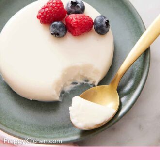 Pinterest graphic of a plate with a serving of panna cotta with berries and a bite scooped onto a spoon.