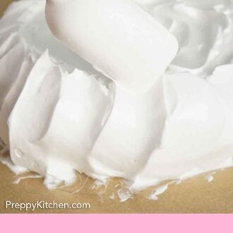 Pinterest graphic of pavlova mixture spread onto a lined sheet pan.