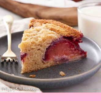 Pinterest graphic of a slice of plum cake on a plate with a glass of milk in the background.