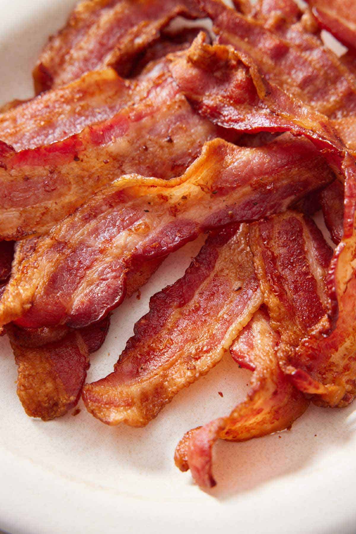 A close up view of air fryer bacon on a plate.