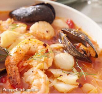 Pinterest graphic of a close view of bouillabaisse in a bowl.