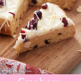 Pinterest graphic of a triangle piece of cranberry bliss bar on a wooden serving board.