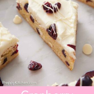 Pinterest graphic of a triangle cut piece of cranberry bliss bar on a marble counter.