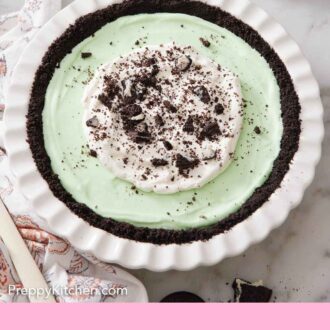 Pinterest graphic of a grasshopper pie in a white baking dish topped with whipped cream and crushed Oreos.