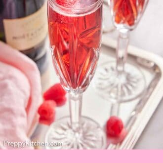 Pinterest graphic of glasses of Kir Royale and a bottle of champagne on a tray.