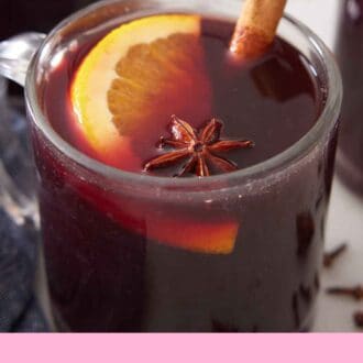 Pinterest graphic of a close up view of mulled wine in a glass.