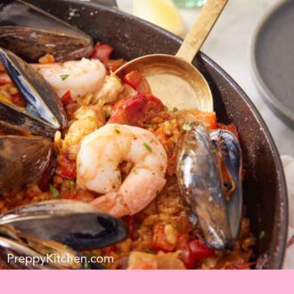 Pinterest graphic of a spoon inserted into a skillet of paella.