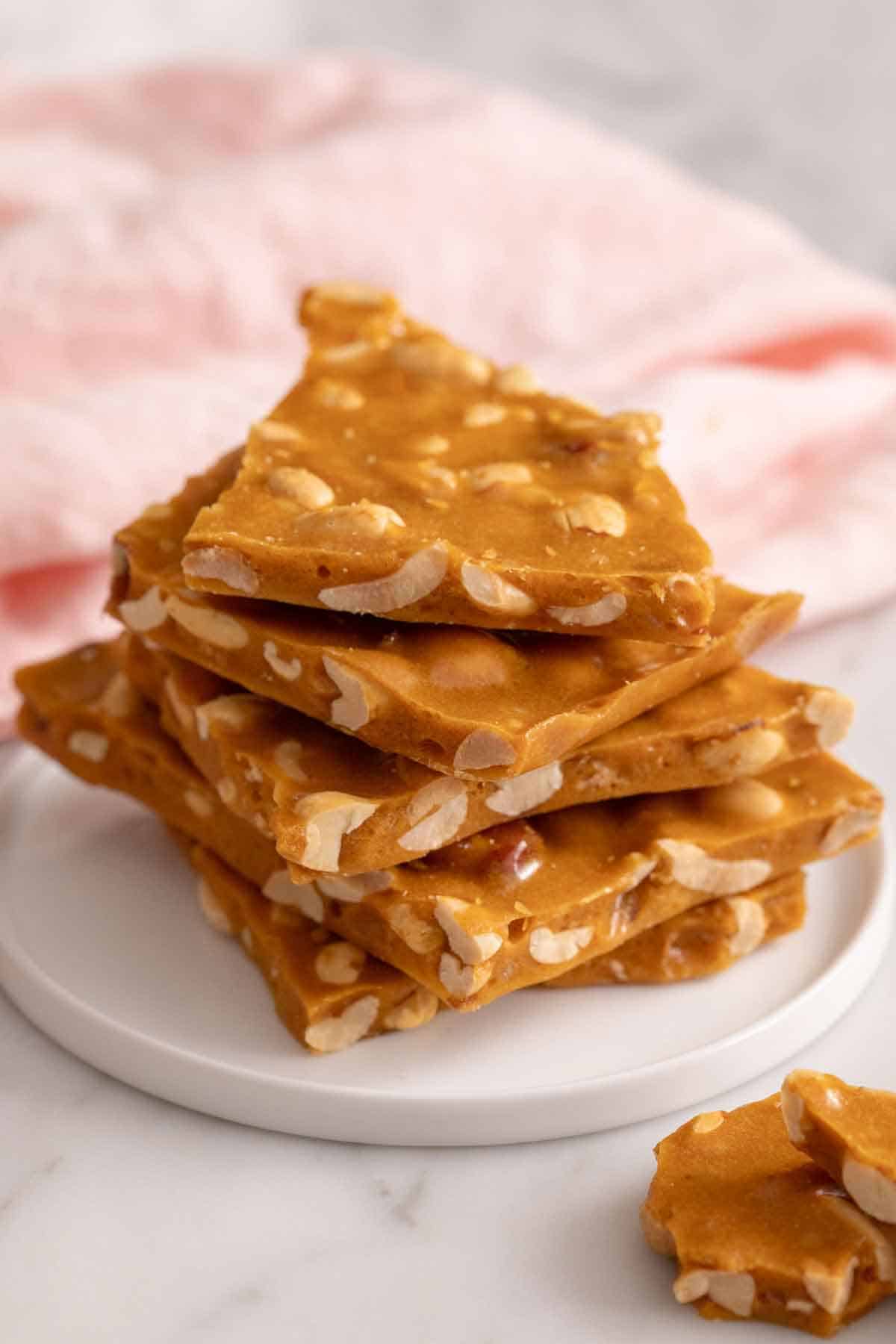 A plate with a stack of peanut brittle.