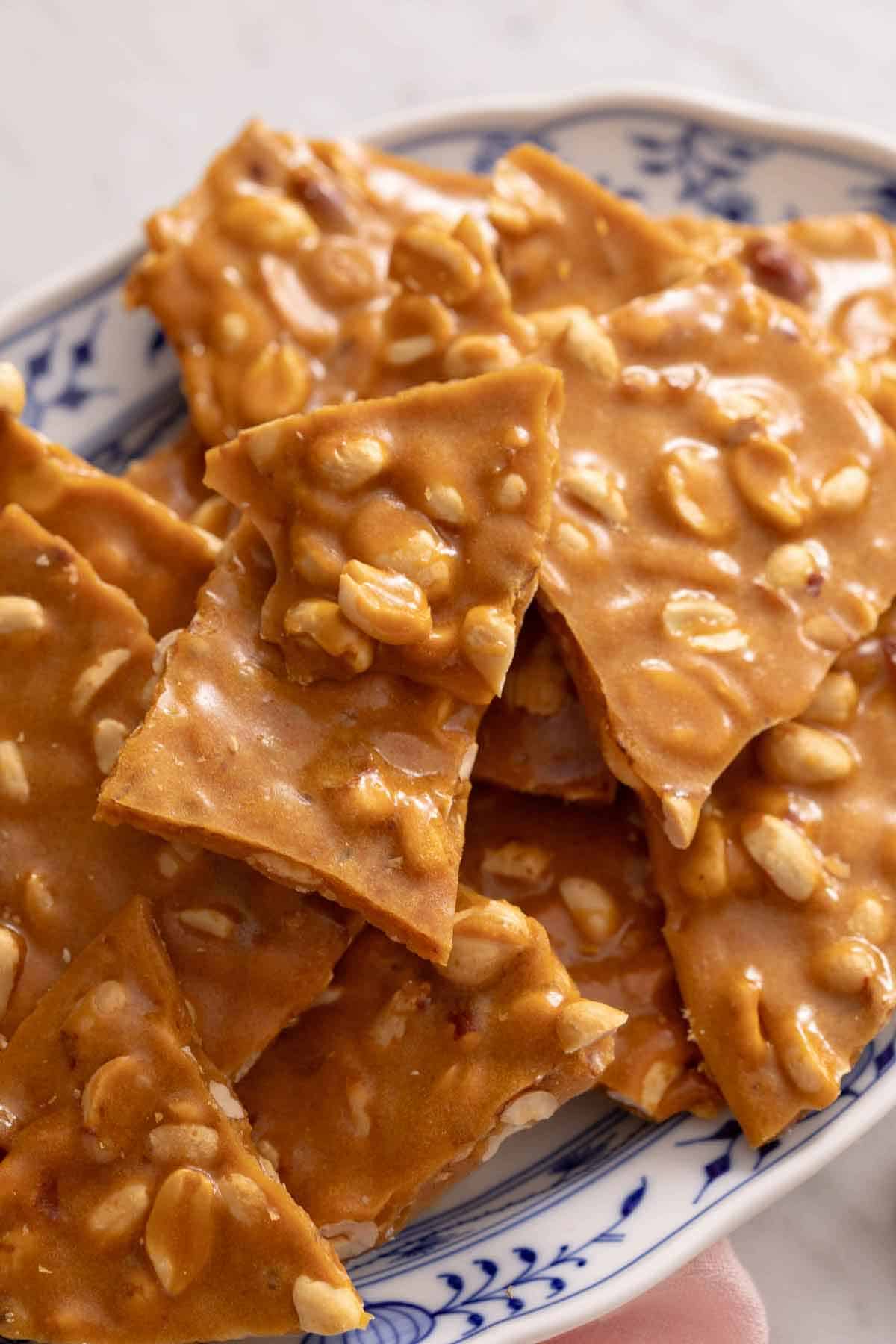 Multiple pieces of peanut brittle on a platter.