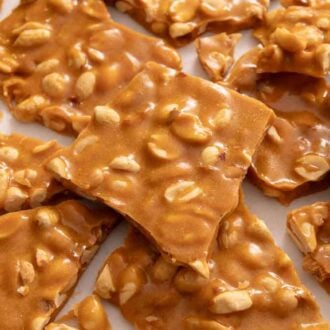 Multiple pieces of peanut brittle on a counter.