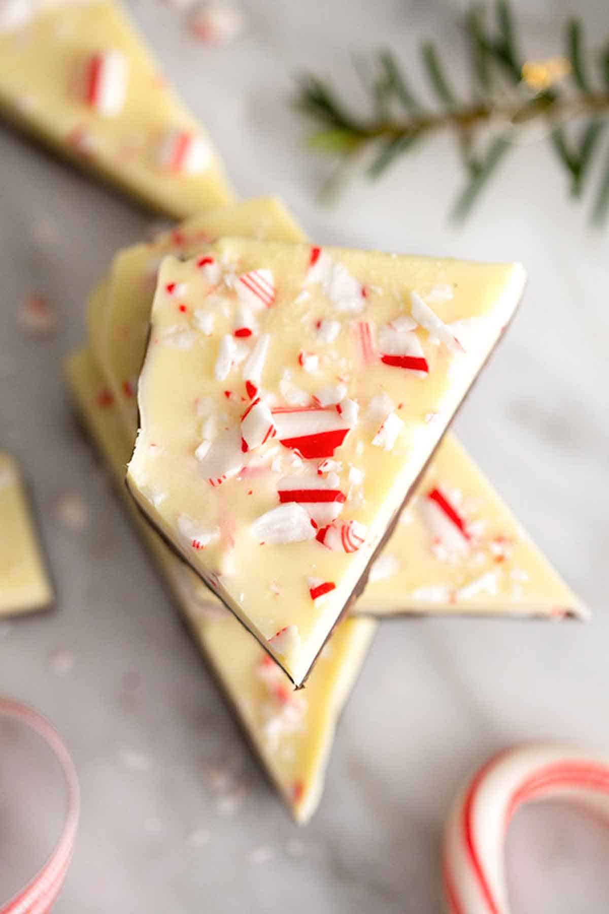 Overhead view of a stack of peppermint bark with crushed candy cane candy on top.