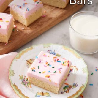 Pinterest graphic of a plate with a sugar cookie bar with a glass of milk and additional sugar cookie bars in the back.