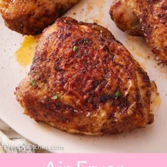 Pinterest graphic of a close up view of air fryer chicken thighs on a plate.