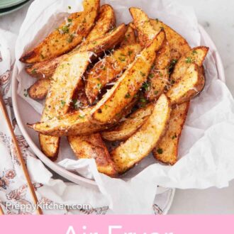 Pinterest graphic of an overhead view of a parchment-lined bowl of air fryer potato wedges topped with parmesan and parsley.