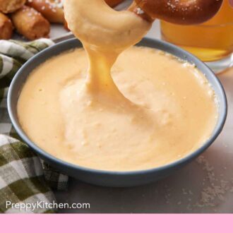 Pinterest graphic of a pretzel dipped into a bowl of beer cheese dip.