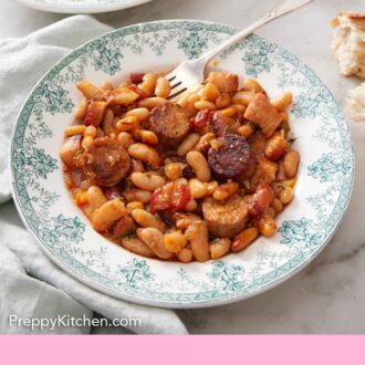 Pinterest graphic of a plate of cassoulet with a fork with a second plate in the background.
