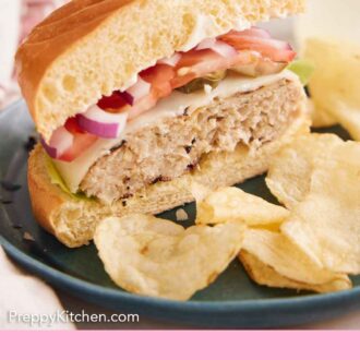 Pinterest graphic of a chicken burger cut in half. Chips on the side.