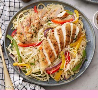 Pinterest graphic of a plate of chicken scampi with two chicken tenderloins sliced on top.