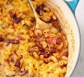 Pinterest graphic of a spoon inside a pot of chili mac.