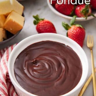 Pinterest graphic of a bowl of chocolate fondue with assorted dippers in the background.