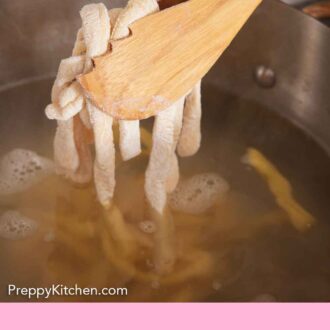 Pinterest graphic of uncooked egg noodles added to a pot of water.