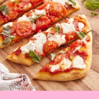 Pinterest graphic of a cutting board with a cut flatbread pizza with some basil.