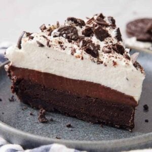 A slightly side view of a slice of mud pie on a plate.