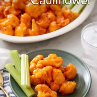 Pinterest graphic of a plate with air fryer buffalo cauliflower and celery sticks with more on a platter in the background.