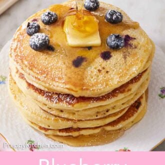 Pinterest graphic of a stack of blueberry pancakes topped with butter with maple syrup poured on top.