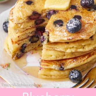 Pinterest graphic of a stack of blueberry pancakes with butter on top with a bite cut out.