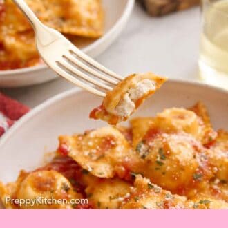 Pinterest graphic of a fork lifting up a bite of cheese ravioli tossed in tomato sauce and herb garnish.