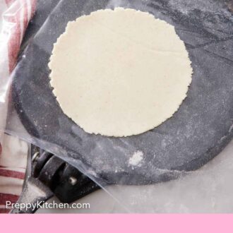 Pinterest graphic of a corn tortilla freshly pressed, on the tortilla press.