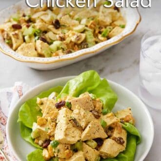 Pinterest graphic of a plate of curried chicken salad over lettuce with a platter of more chicken salad in the background.