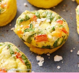 Pinterest graphic of a close up view of egg muffins with feta scattered around.